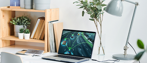 A modern, minimalist desk setup with a laptop displaying a simulation of autonomous vehicles using LiDAR technology. The screen shows cars on a road with green sensor lines indicating AI-based detection or navigation. Surrounding the laptop are a desk lamp, books, and indoor plants, creating a clean and tech-savvy workspace.









